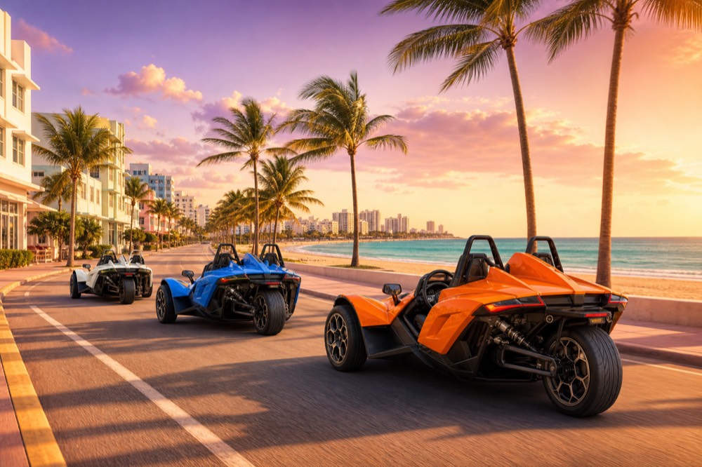 Three Polaris Slingshots in convoy on a Miami beachfront road